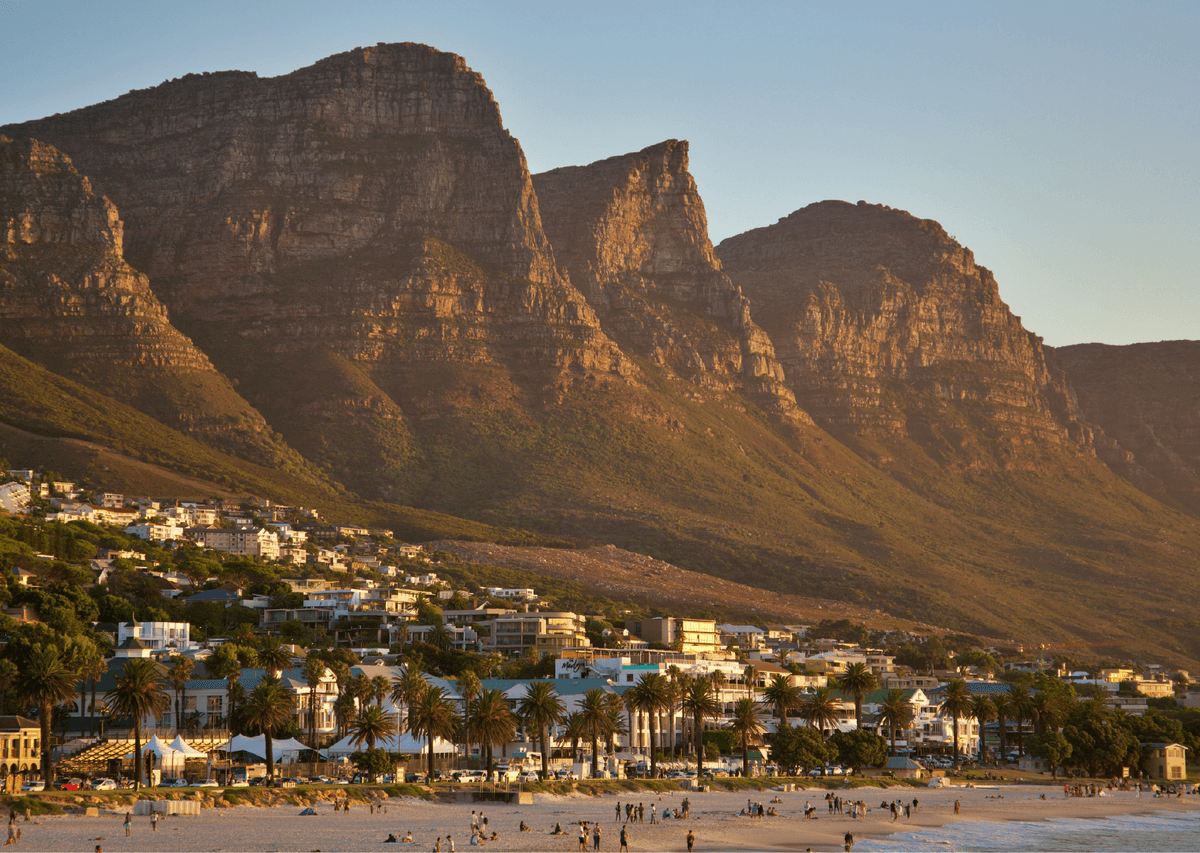 Golden-hour view of the Twelve Apostles mountain range above Camps Bay beach and The Marly hotel